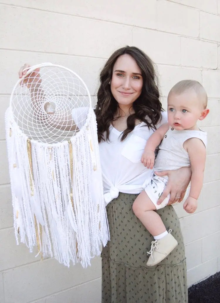 White dreamcatcher with spiral web and tassels from Brianne Froeber’s small shop.
