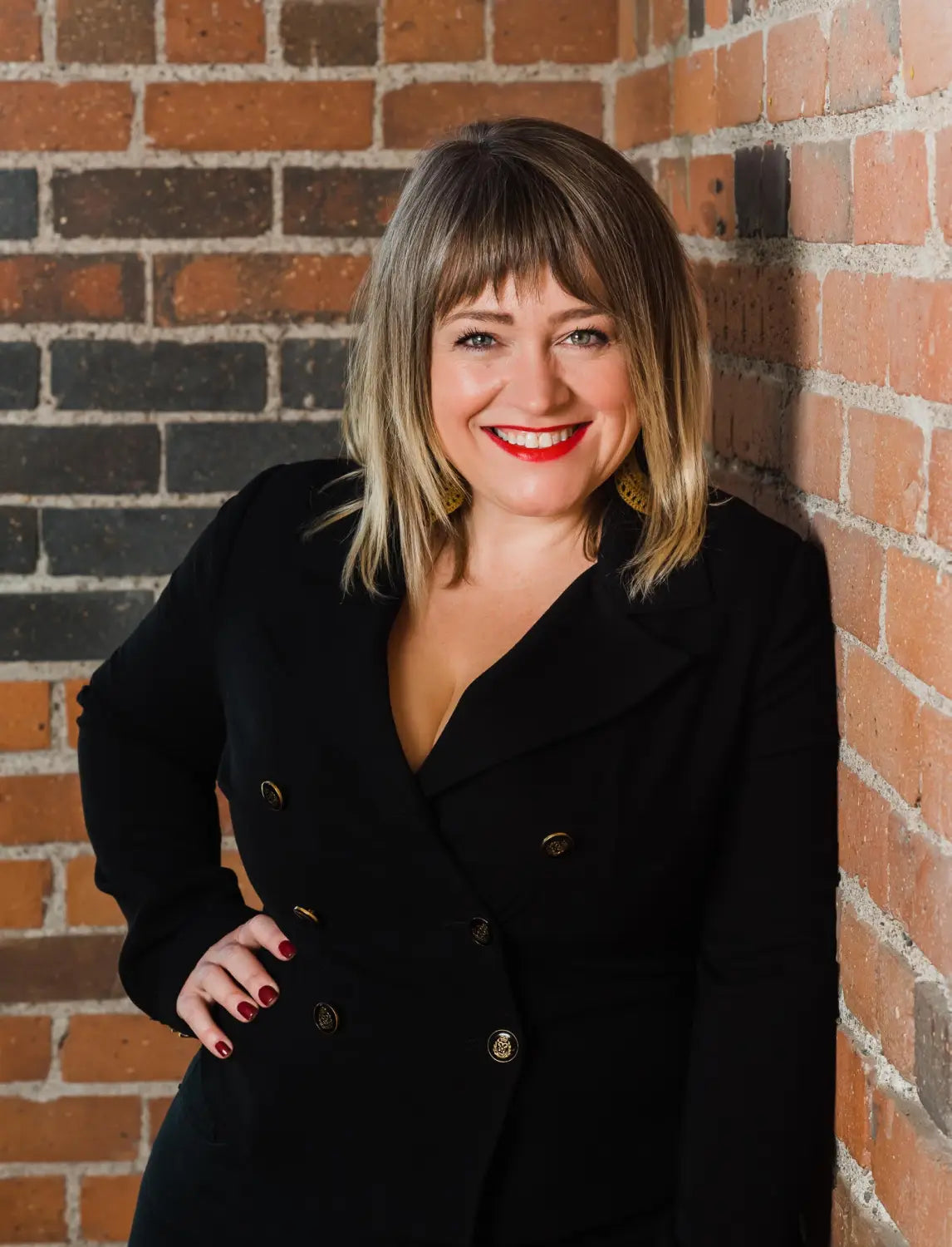 Smiling person in a blazer shares tips on reducing stress and boosting intimacy.