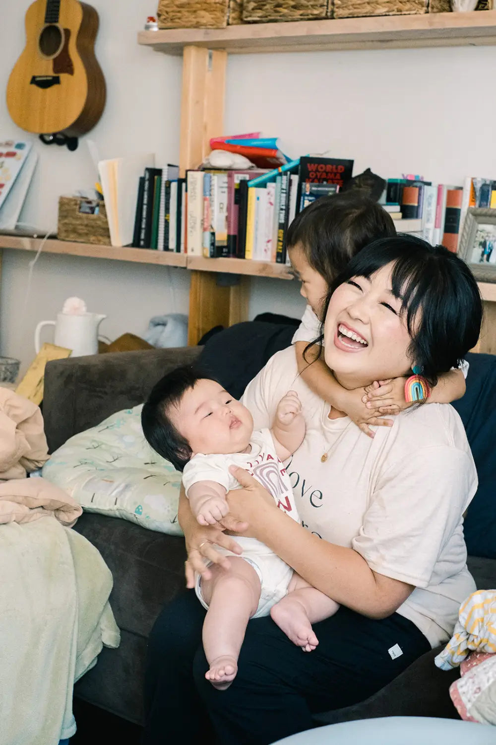 Joyful laughter between parent and baby, celebrating love in Lisa Aihara’s graphic design.