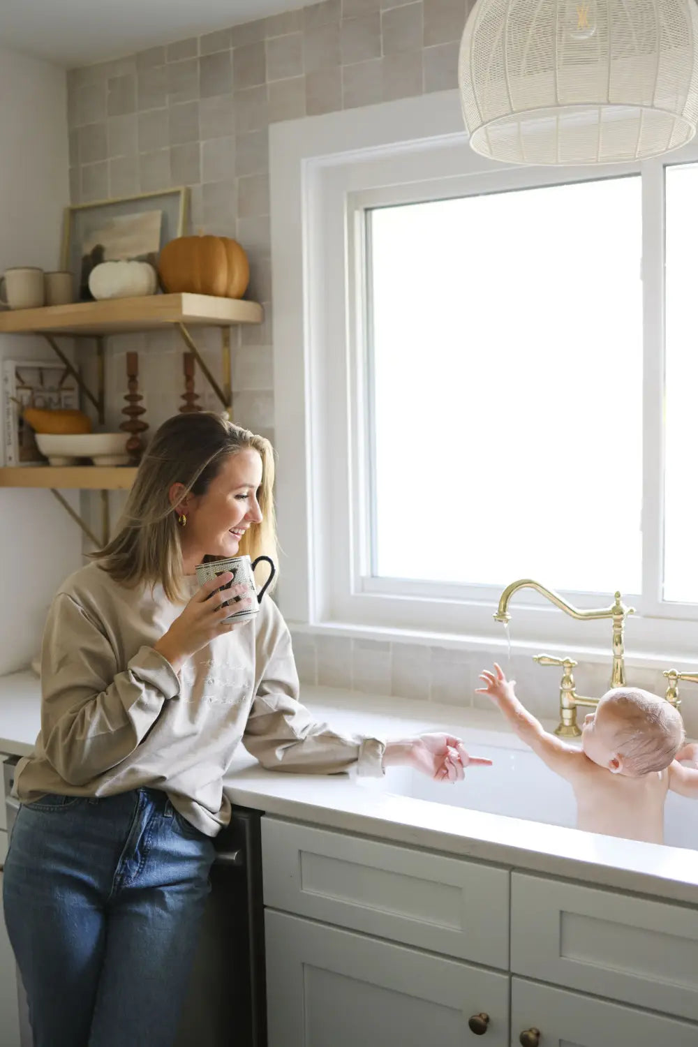 A new mom enjoying a cozy drink in the Peace Signs Camp Collection kitchen.