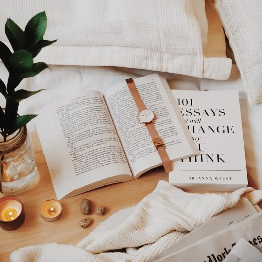 Open book with a leather watch strap, featuring Author Brianna Wiest’s global bestseller