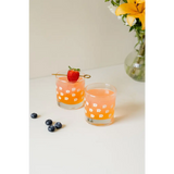 Two orange cocktails in floral glasses showcasing a heavy-based 11oz checkered design