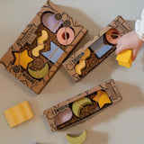 Cardboard boxes with fun designs holding colorful natural rubber geometric figures