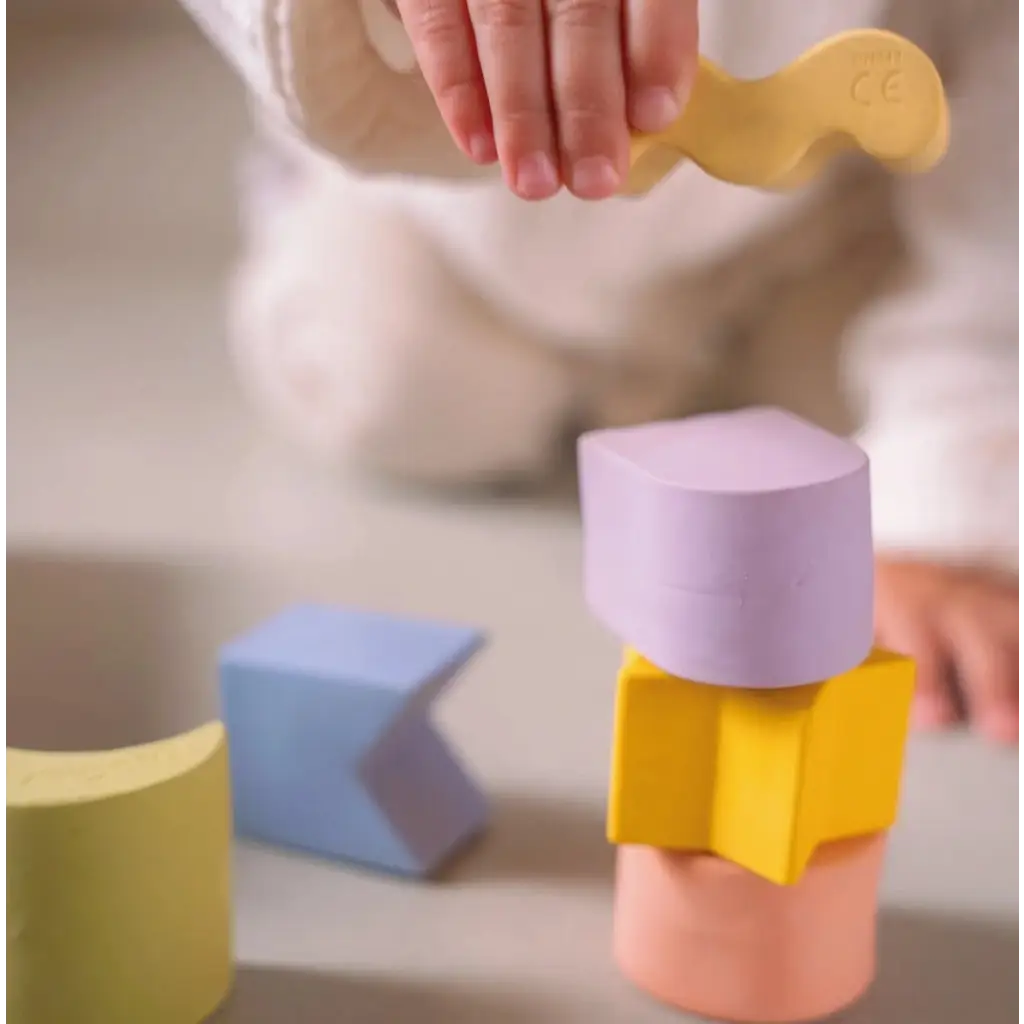 Colorful floating stacking blocks made of natural rubber shaped like geometric figures