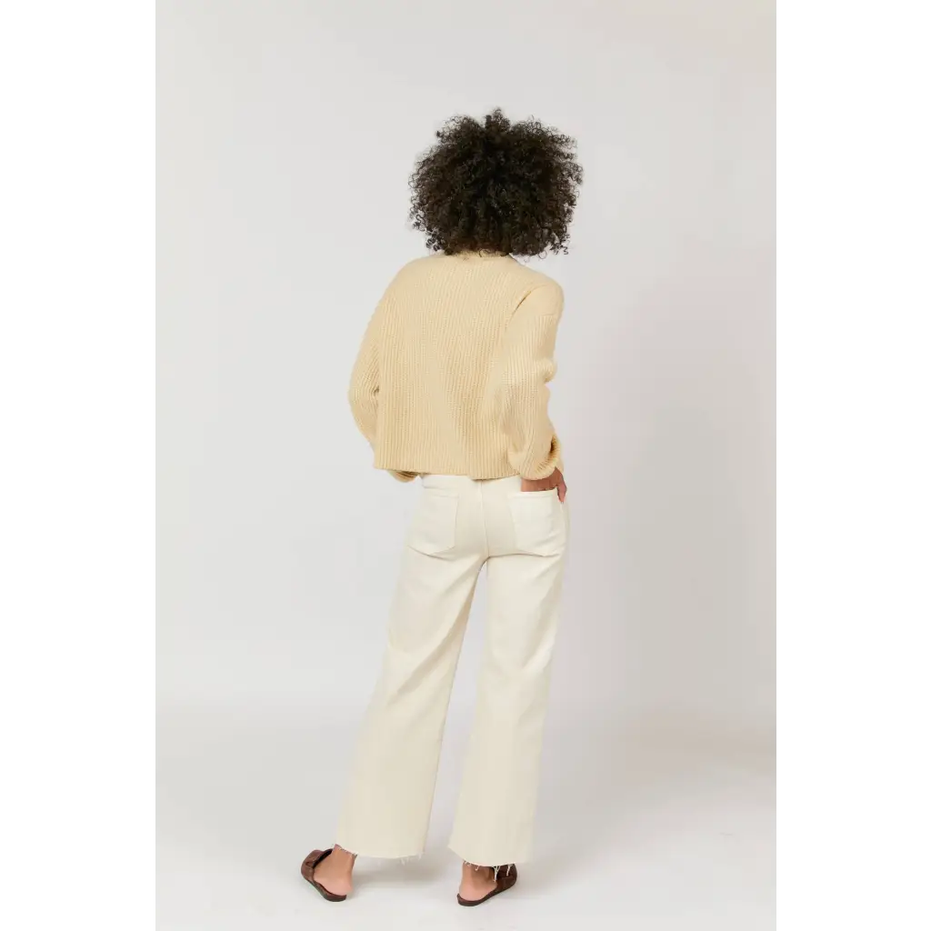 Cream-colored linen blazer with high rise wide-leg pants and black sandals