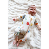Baby in a white polka dot Smiles Bamboo Baby Sleeper, comfy and cute!