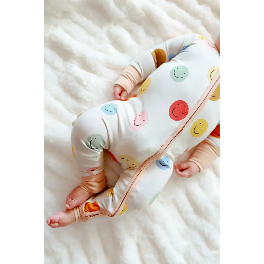 Baby sleepwear featuring colorful smiley faces on the All Smiles Bamboo Baby Sleeper