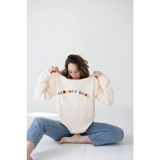 Cream-colored sweatshirt with colorful ALREADY GOOD text for a comfy organic cotton look