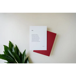 White paper with poetry next to a red notebook and green leaf, free shipping featuring art