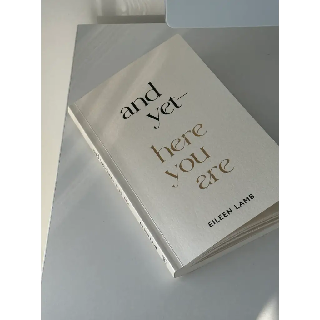 White book titled And Yet Here You Are by Eileen Lamb, available in St. Louis