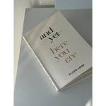 White book titled And Yet Here You Are by Eileen Lamb, available in St. Louis