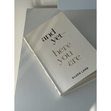 White book titled And Yet Here You Are by Eileen Lamb, available in St. Louis