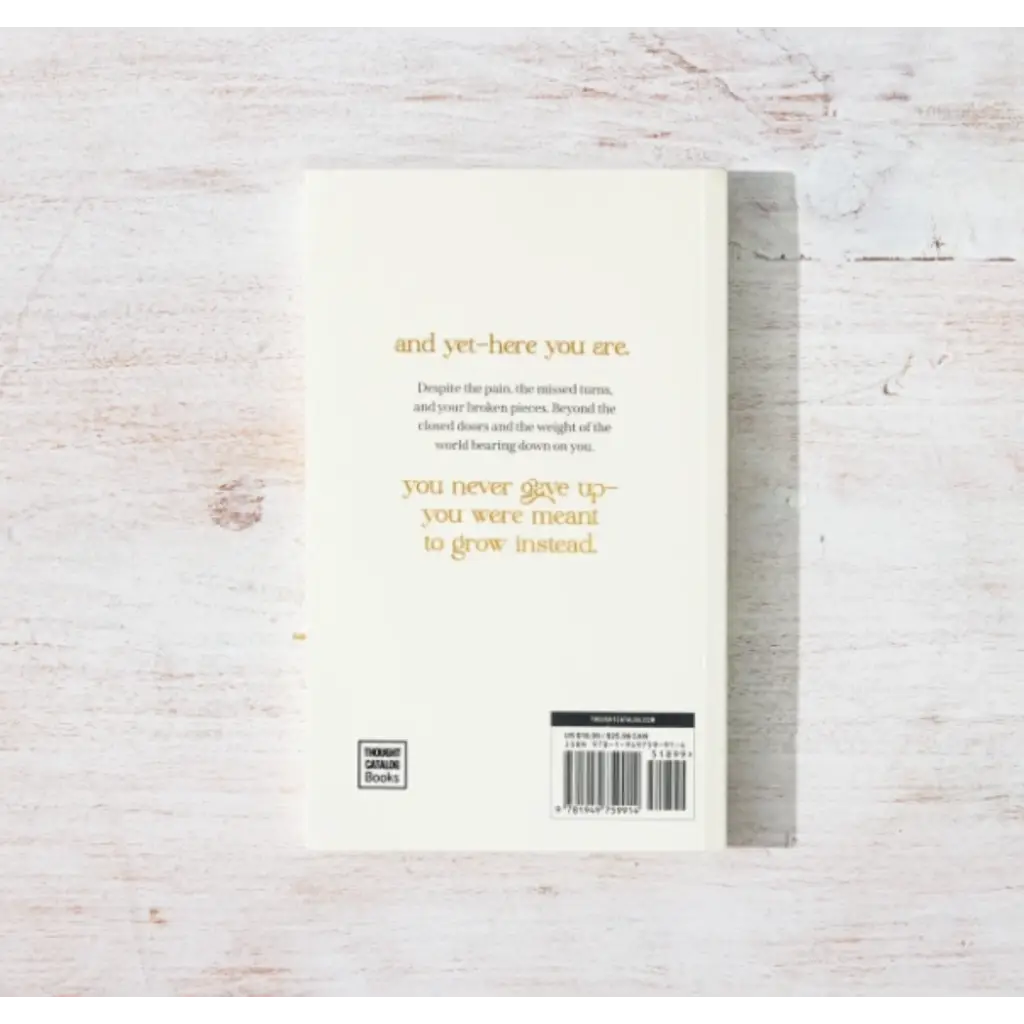 White book with gold text on back cover titled And Yet – Here You Are by Eileen Lamb