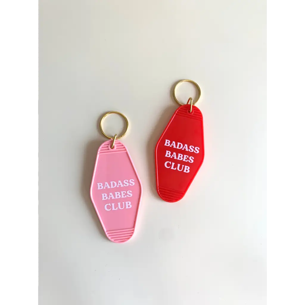 Two retro motel keychains in pink and red for the Badass Babes Club vibe