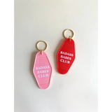 Two retro motel keychains in pink and red for the Badass Babes Club vibe