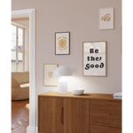 Wooden credenza with a white lamp and Good Vibes 8x10 wall print for decor