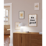 Wooden credenza with a white lamp and Good Vibes 8x10 wall print for decor