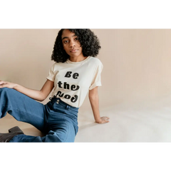 White Be the Good Adult Unisex Crew Neck T-shirt styled with blue jeans