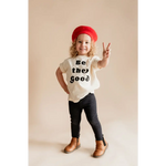 Child in a red beret rocking a Be the Good organic cotton graphic t-shirt by Polished Prints