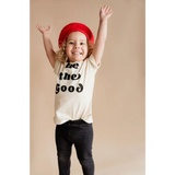 Joyful figure in red beret and Be the Good Organic Cotton Graphic T-shirt by Polished Prints