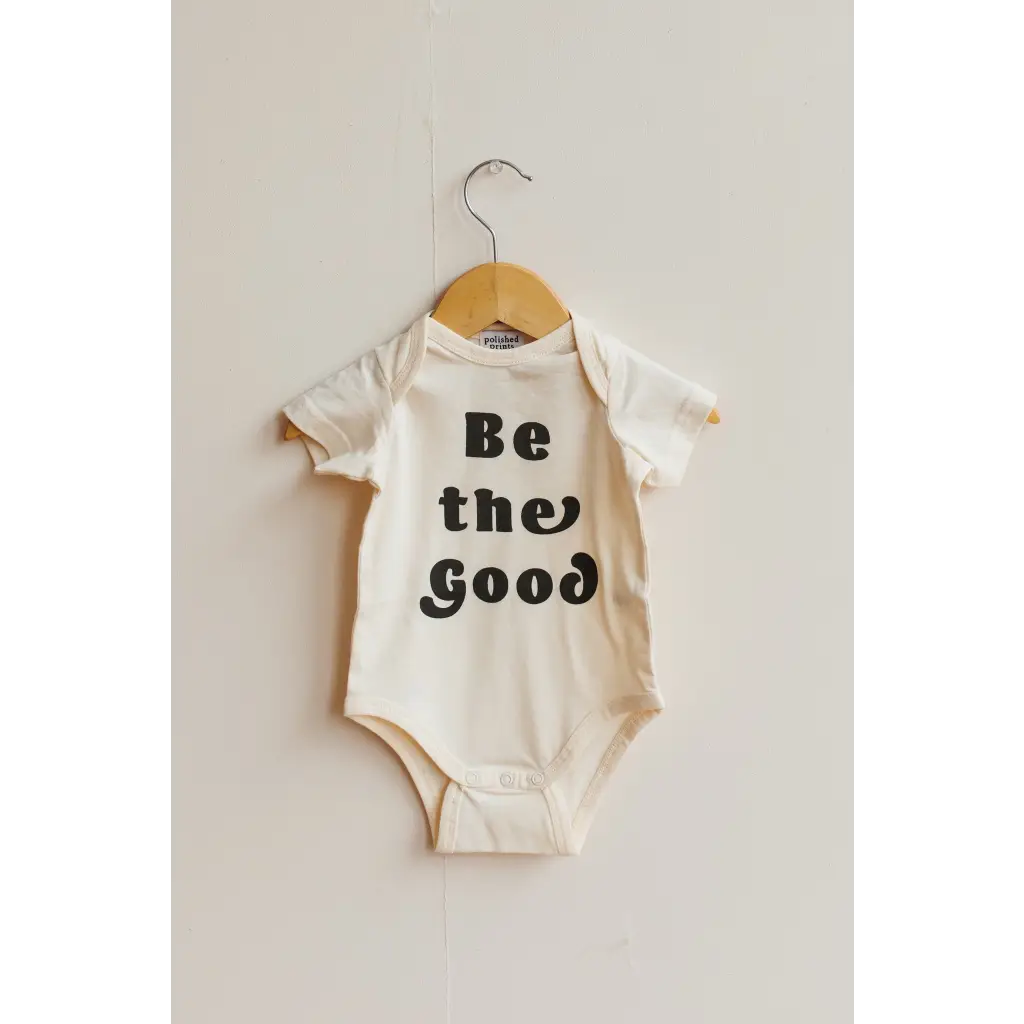 White baby onesie with Be the Good text, perfect organic cotton baby bodysuit