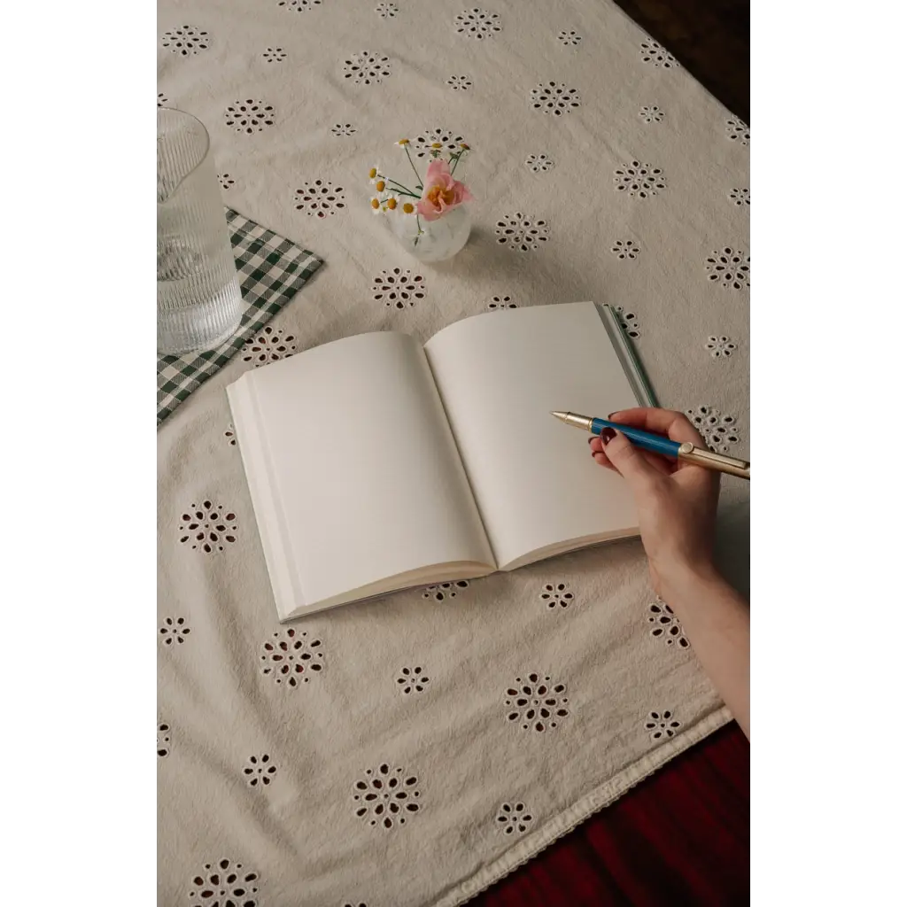 Open blank notebook with pen, perfect for stylish womens clothes or clothes for moms