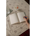 Open blank notebook with pen, perfect for stylish womens clothes or clothes for moms
