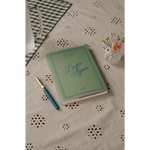 Green Begin Again journal with polished prints in stylish womens clothes for moms