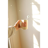 Beige 15oz extra large mug with red text from Behind Every Woman collection