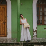 Woman in white dress with cosmic print tote kit showcasing block printing skills