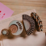 Assorted wooden printing blocks for blok parti block printing and polished prints in tote kit