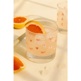 Pink grapefruit juice in Bow Cocktail Glass Set with peace signs camp vibe and pink bow design