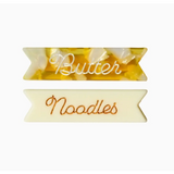 Cute butter noodles hair clips featuring cursive labels for a fun style