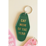 Bright green Cat Mom motel keychain with gold text, perfect for proud cat moms