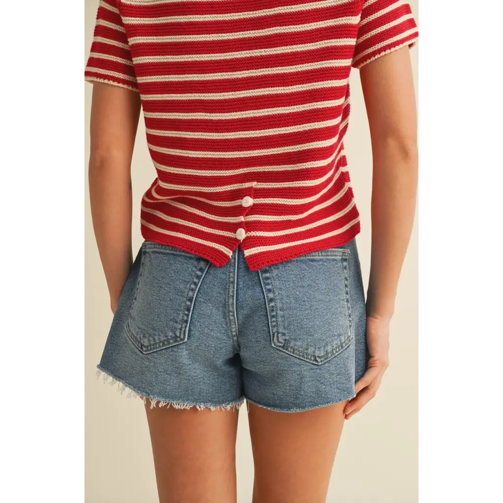 Red and white striped short sleeve sweater top paired with light-wash denim shorts