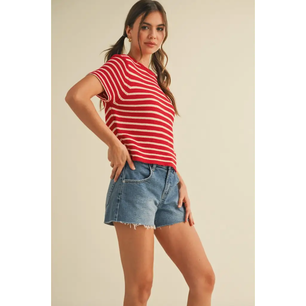 Woman in Channel Short Sleeve Striped Sweater Top with red and white stripes and denim shorts