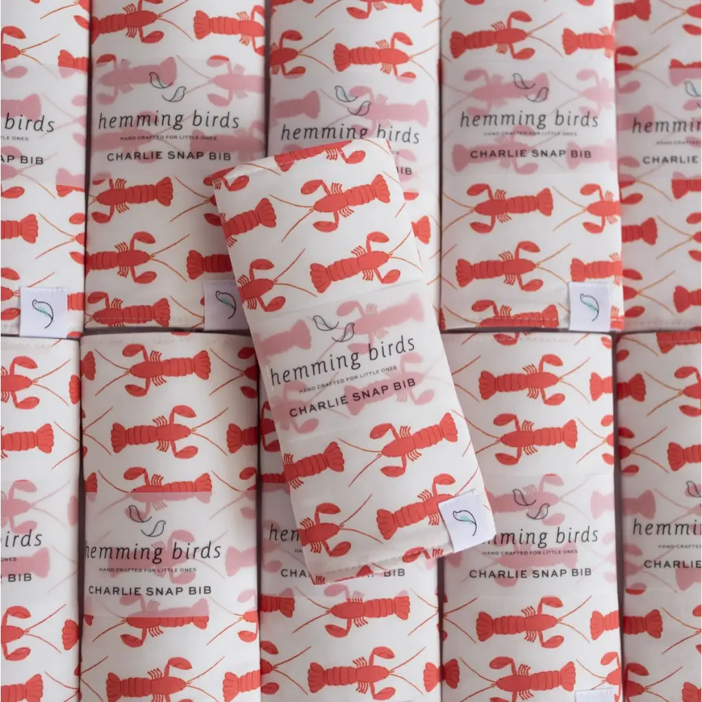 Rolls of wrapping paper with red lobster patterns for Navy Charlie Snap Bibs