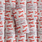 Rolls of wrapping paper with red lobster patterns for Navy Charlie Snap Bibs