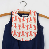 Navy Charlie Snap Bib with coral lobster prints over a cute sleeveless romper for kids