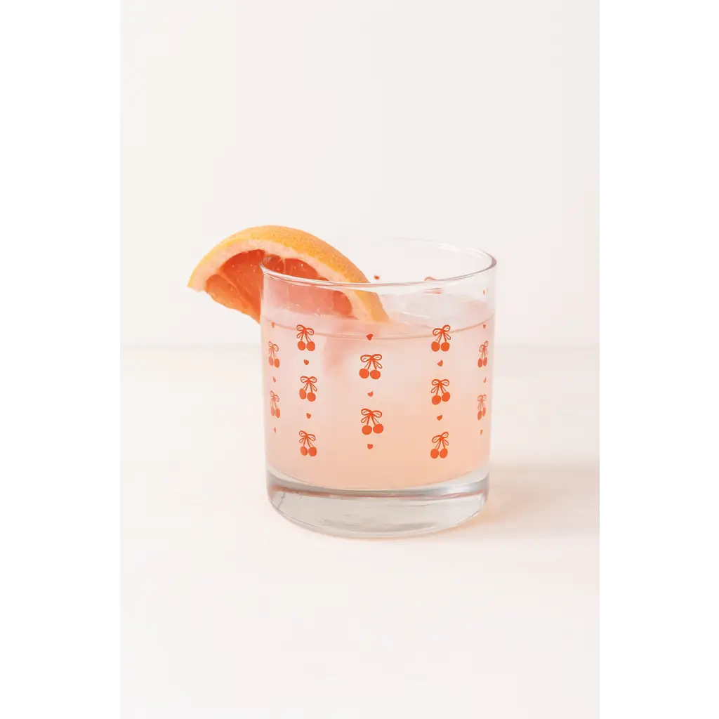 Pink grapefruit cocktail in a clear Cherries Cocktail Glass with cherry patterns, perfect for signs camp flag or mom tank fans