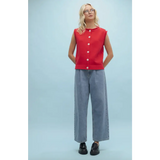 Woman in red top and wide-leg jeans wearing Cherry Red Sweater Button-Up Vest for stylish womens clothes
