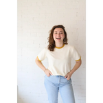 Smiling woman wearing Classic Women’s Ringer Tee made of organic cotton with polished prints