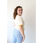 Woman in Cream and Yellow Ringer Tee in Mustard made from organic cotton with polished prints