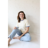 Woman in a Navy Classic Womens Ringer Tee made of organic cotton with polished prints