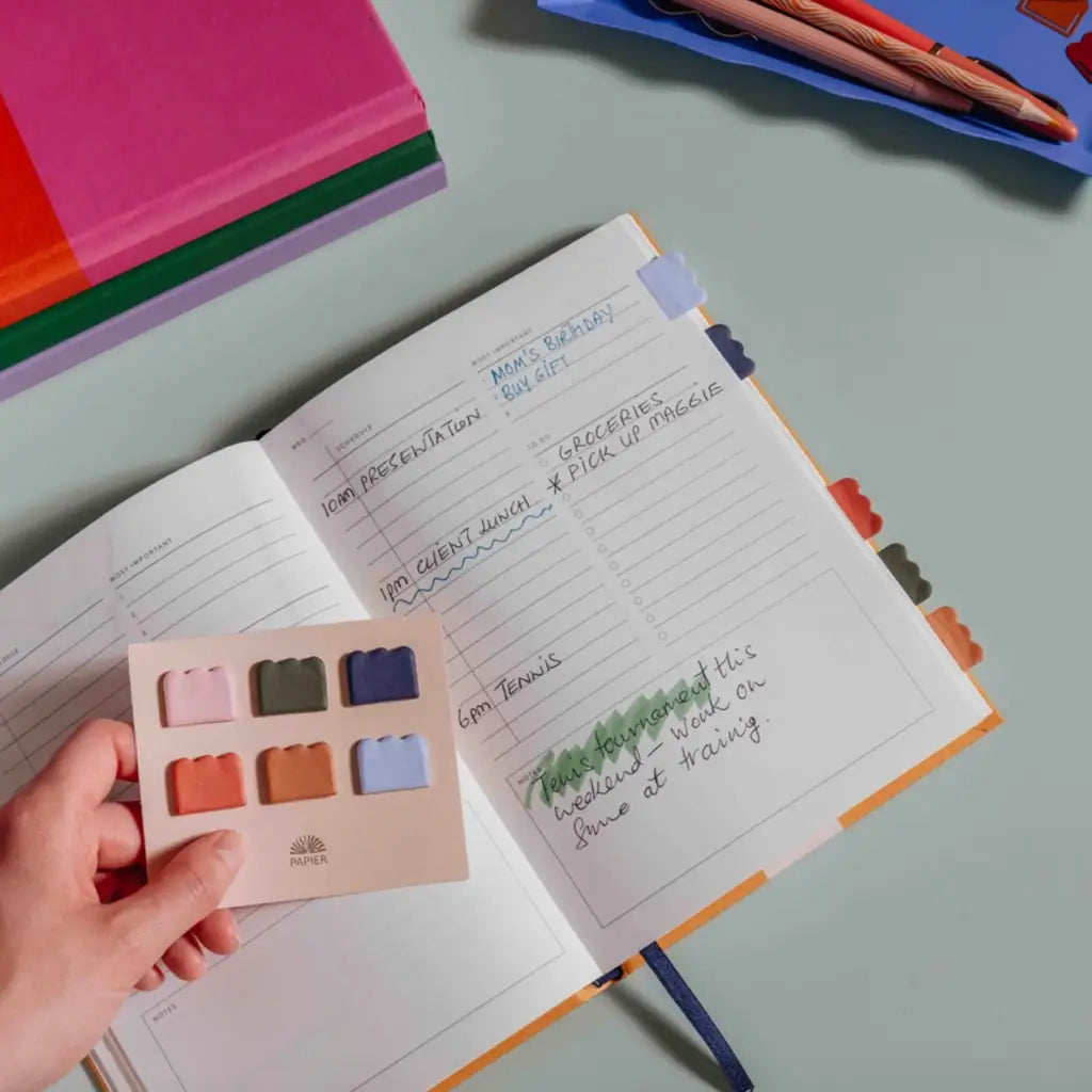 Open planner with colorful sticky notes showing Cloud Sticky Index Tabs and sticky index tabs