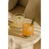 Two refreshing cocktails in Cowboy Cocktail Glasses with rosemary, perfect for peace signs camp