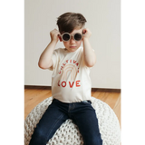 White Cultivate Love Organic Cotton T-shirt for Kids styled with jeans and round sunglasses