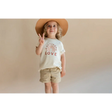 Child in a wide-brimmed hat and LOVE t-shirt promoting Cultivate Love Organic Cotton for kids