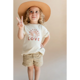 Kid rocking a Cultivate Love Organic Cotton T-shirt, peace sign, and cute hat