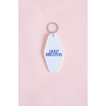 White vintage hotel keychain with Deep Breaths text in blue for calm moments